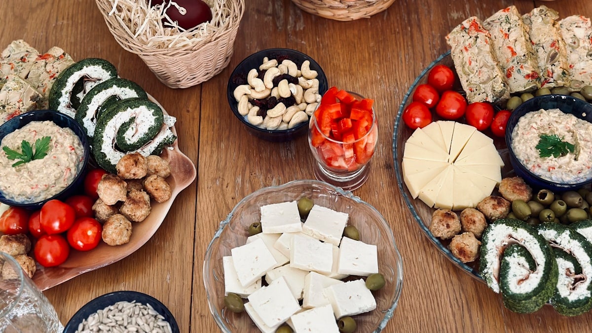 a wooden table topped with plates of food